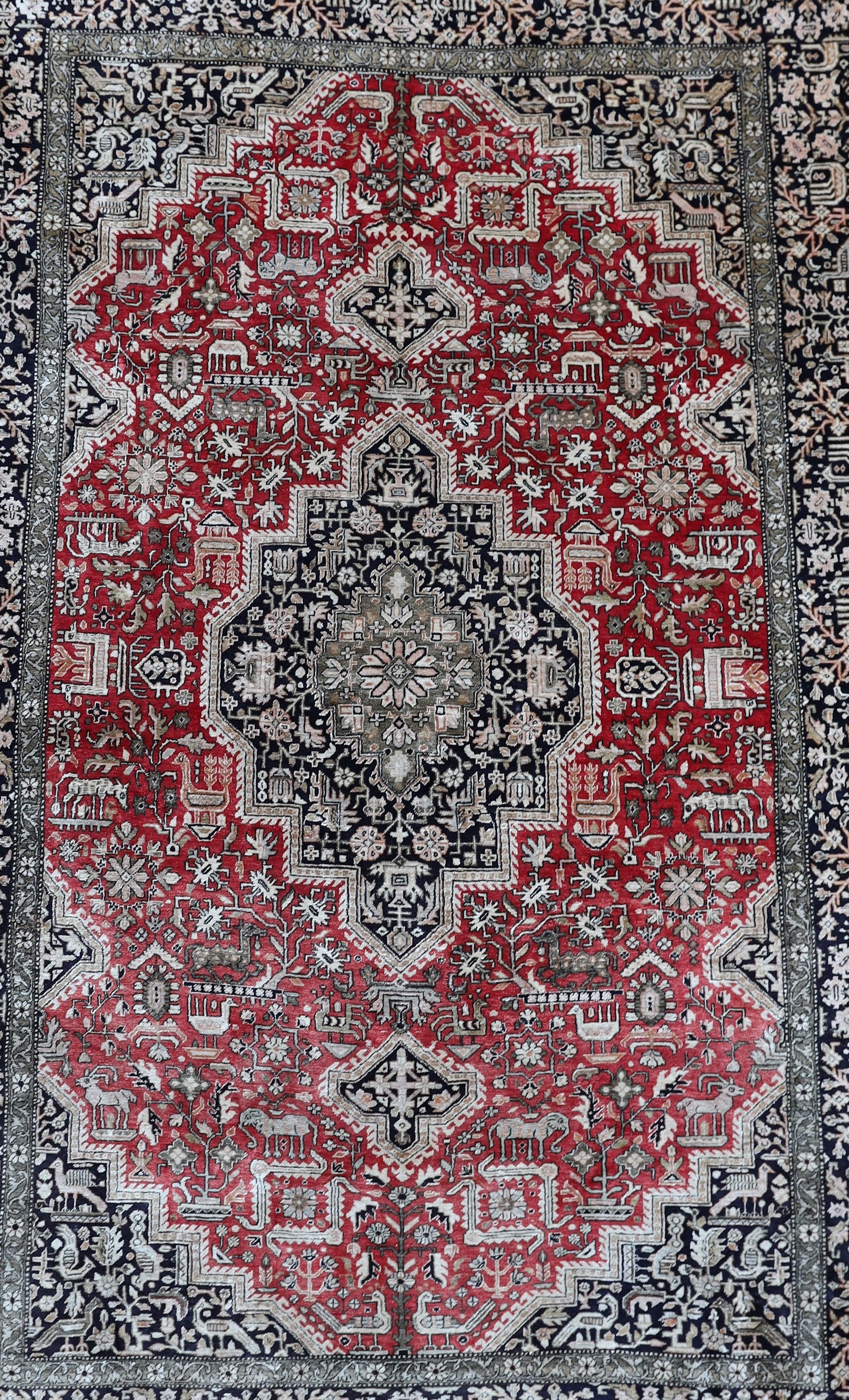An early 20th century Caucasian silk red ground rug, 206 x 132cm.